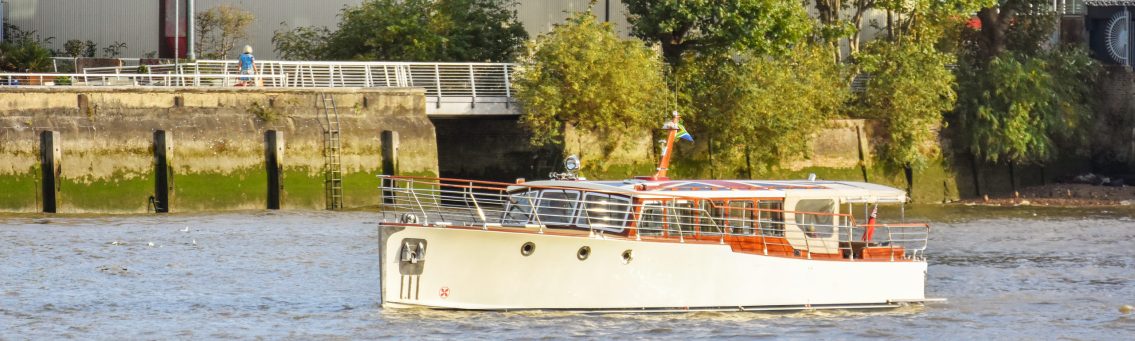 Bourne Luxury Boat Sailing on Thames with South African and England Flag.